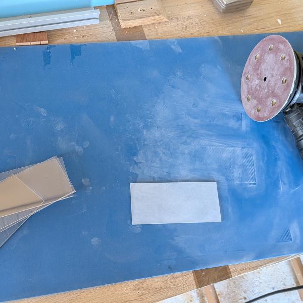 I sanded the flat surface with a random orbital sander to a 180 grit.